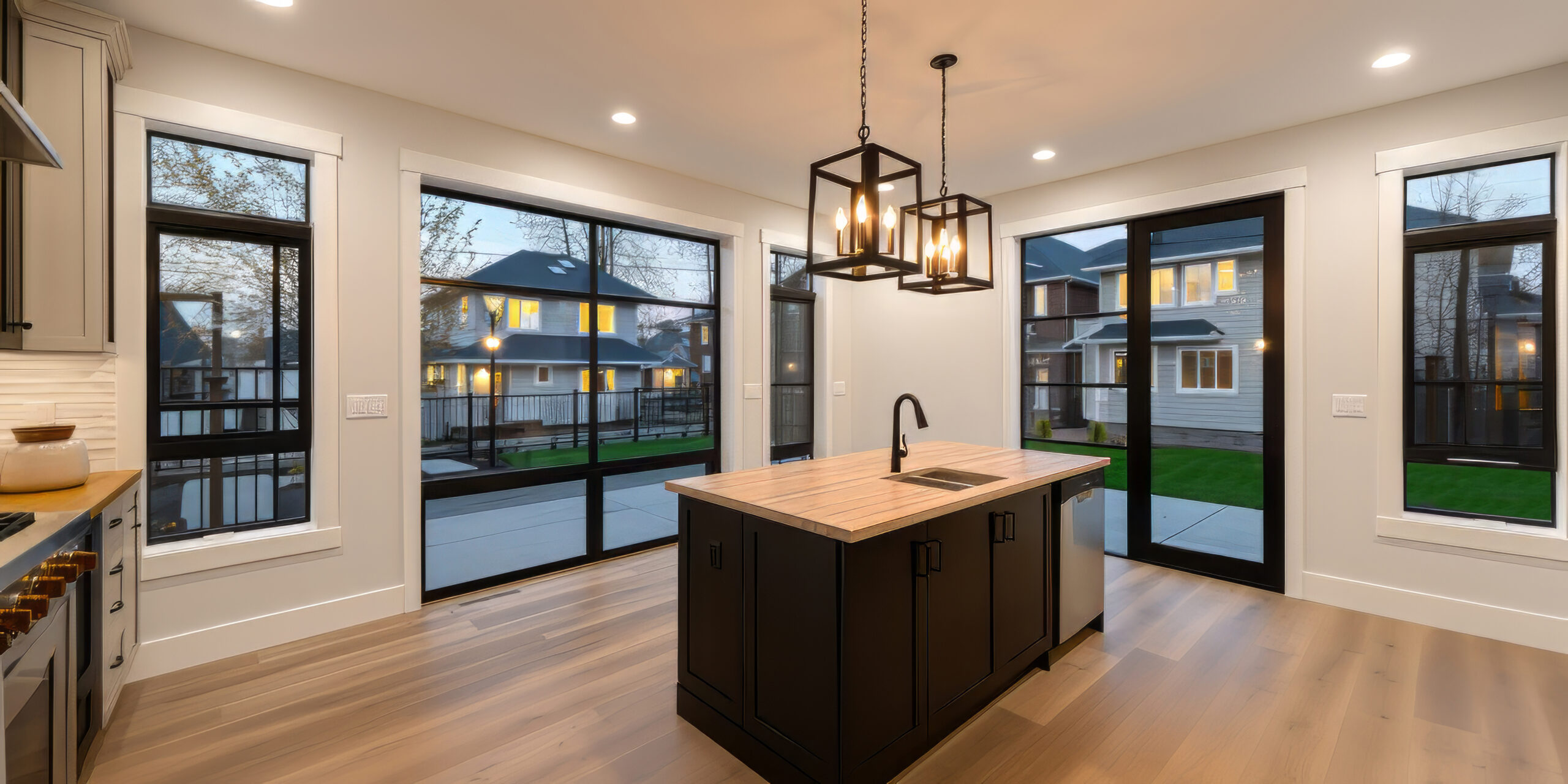 Kitchen Interior with Island, Sink, Cabinets, and Hardwood Floors in New Luxury Home. Features Elegant Pendant Light Fixtures, and Farmhouse Sink next to Window A white background object transparent --c 99 --ar 2:1 --q 2 --s 250 --v 5.2